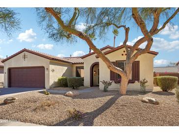 One-story house with brown accents and desert landscaping at 19241 N Emerald Cove Way, Surprise, AZ 85387