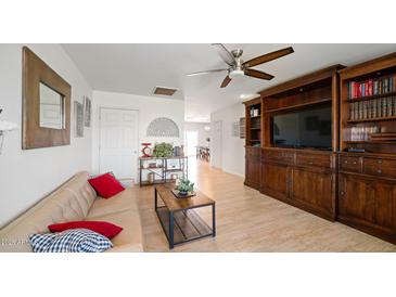 Bright living room features a comfy sofa and built-in shelving at 3737 W Morrow Dr, Glendale, AZ 85308