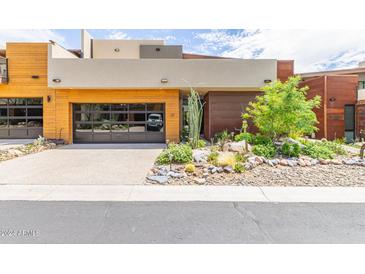 Modern home with wood and metal siding, landscaped yard, and two-car garage at 6525 E Cave Creek Rd # 20, Cave Creek, AZ 85331