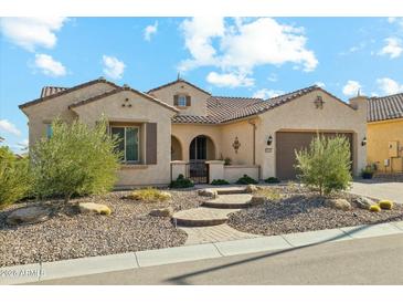 Single-story home with a welcoming front porch and landscaped yard at 7805 W Noble Prairie Way, Florence, AZ 85132