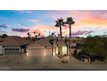 Beautiful two-story home with a three-car garage and desert landscaping at 14848 W Edgemont Ave, Goodyear, AZ 85395