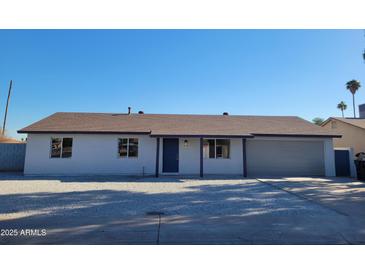 Newly renovated single story home with a modern exterior and front yard landscaping at 1633 N 62Nd Ave, Phoenix, AZ 85035