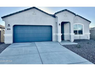 Single-story home with a two-car garage and neutral color scheme at 18381 W Gray Fox Trl, Wittmann, AZ 85361