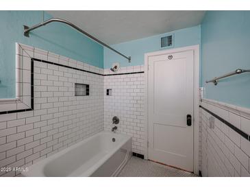 White subway tile and a classic bathtub in this bathroom at 2232 N 13Th St, Phoenix, AZ 85006