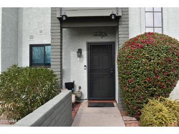 Condo entrance with a private walkway and landscaping at 2315 W Union Hills Dr # 112, Phoenix, AZ 85027