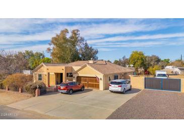 Single-story home with a large driveway and gated entrance at 3848 W Morrow Dr, Glendale, AZ 85308