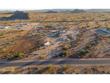 Aerial view of a large property with multiple buildings and a riding arena at 49651 W Dune Shadow Rd, Maricopa, AZ 85139