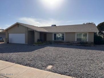 Single-story house with a large front yard and a two-car garage at 5215 W Acapulco W Ln, Glendale, AZ 85306