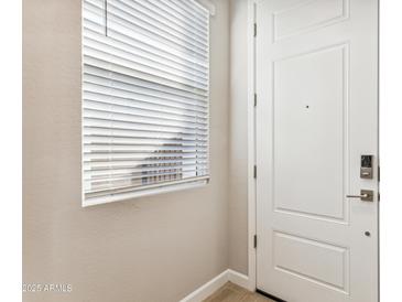 Interior entryway with white door and window blinds at 5846 E Ringtail Way, Phoenix, AZ 85054