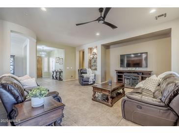 Spacious living room featuring comfortable seating and a large TV at 6830 S Crystal Way, Chandler, AZ 85249