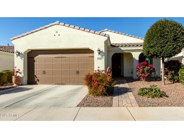 Single-story home with a two-car garage and landscaped front yard at 14200 W Village Pkwy # 2128, Litchfield Park, AZ 85340