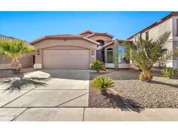 Desert landscape front yard with single story home, two car garage, and neutral color scheme at 29864 N Desert Willow Blvd, San Tan Valley, AZ 85143