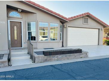 Charming single-story home featuring a two-car garage and a red tile roof at 3301 S Goldfield Rd # 3038, Apache Junction, AZ 85119