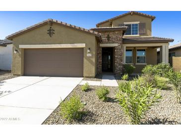 Two-story house with stone accents and a landscaped front yard at 5660 N 188Th Ln, Litchfield Park, AZ 85340