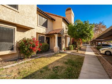 Inviting exterior of a two-story townhome with landscaping and parking at 921 W University Dr # 1136, Mesa, AZ 85201