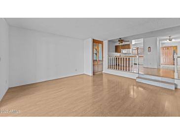 Bright living room with wood floors and view into kitchen at 100 N Vulture Mine Rd # 101, Wickenburg, AZ 85390