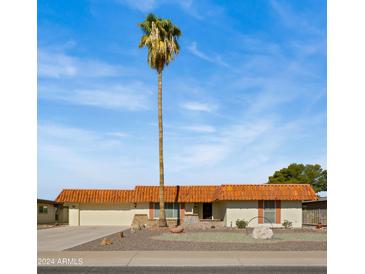 Single-story home with a terracotta tile roof and a landscaped front yard at 11022 W Boswell Blvd, Sun City, AZ 85373