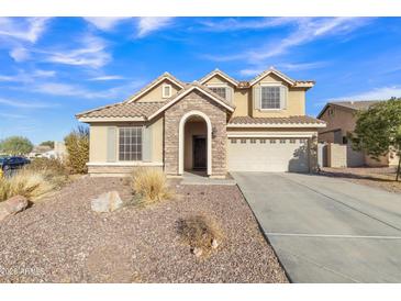 Two-story house with stone accents and a three-car garage at 11506 E Sylvan Ave, Mesa, AZ 85212