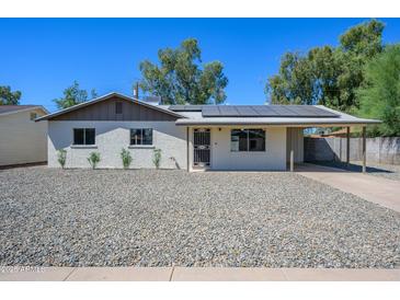 Newly renovated home with solar panels and a gravel front yard at 14626 N 36Th Pl, Phoenix, AZ 85032