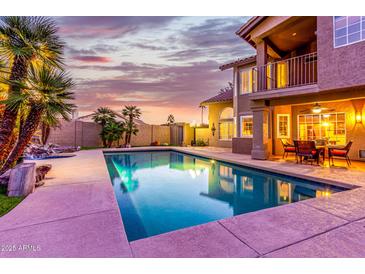 Inviting swimming pool with patio and seating area at sunset at 15237 S 19Th Way, Phoenix, AZ 85048