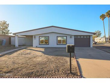 Newly renovated single story home with a landscaped yard and attached garage at 1637 W Tierra Buena Ln, Phoenix, AZ 85023