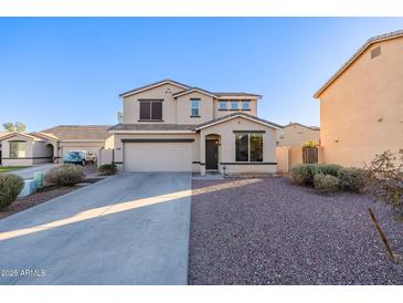 Two-story house with a double garage and landscaped front yard at 1647 W Gold Mine Way, San Tan Valley, AZ 85144