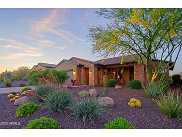 Stunning desert landscape surrounds this single-story home with a welcoming front porch at 17716 E Silver Sage Ln, Rio Verde, AZ 85263