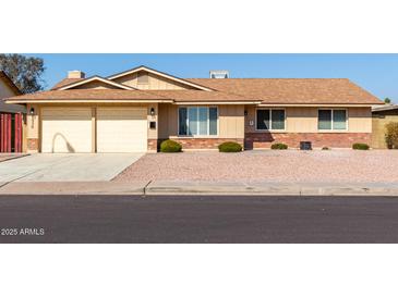 Ranch style home with a two-car garage and well-maintained landscaping at 1936 E Cornell Dr, Tempe, AZ 85283