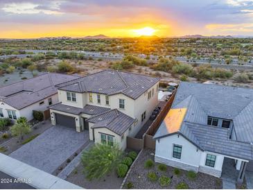 Luxury two-story home with landscaped yard, pool, and mountain views at sunset at 22034 N 59Th Pl, Phoenix, AZ 85054