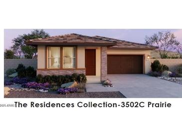 Single-story home with brown garage door and landscaping at 22343 W Monona Ln, Surprise, AZ 85387