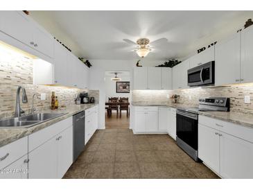 Bright kitchen with stainless steel appliances and tile flooring at 4048 W Sierra Vista Dr, Phoenix, AZ 85019