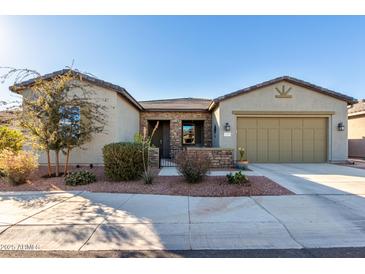 Single-story home with two-car garage and desert landscaping at 42085 W Morning Glory Way, Maricopa, AZ 85138