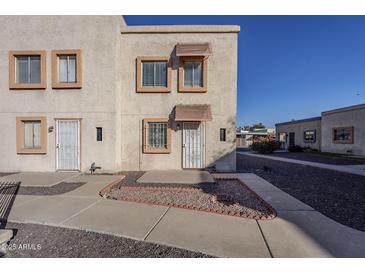 View of the two-story building's exterior, showing the stucco siding and landscaping at 4565 N 26Th Dr, Phoenix, AZ 85017