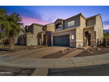 Two-story house with a dark-gray garage door and desert landscaping at 8137 N 13Th Pl, Phoenix, AZ 85020