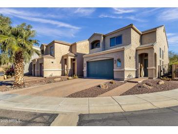 Two-story home with a teal garage door and desert landscaping at 8137 N 13Th Pl, Phoenix, AZ 85020