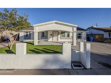 Newly renovated home with a modern facade and well-manicured lawn at 8230 W Monterey Way, Phoenix, AZ 85033