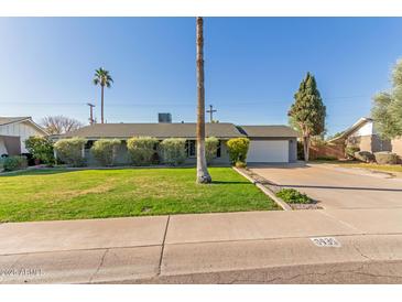 Single story home with a spacious lawn and attached garage at 8435 E Catalina Dr, Scottsdale, AZ 85251