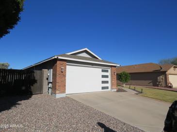 Modern garage with white door and brick exterior at 8828 E Des Moines St, Mesa, AZ 85207