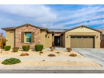 Single-story home with stone accents and a two-car garage at 18934 W Sierra St, Surprise, AZ 85388