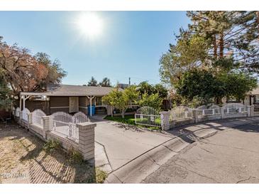 Ranch-style home with a fenced yard and driveway at 3601 W Solano Dr, Phoenix, AZ 85019