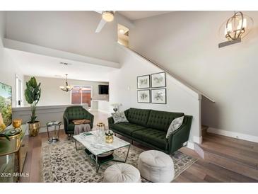 Spacious living room featuring a green sofa and a view into the kitchen at 15550 N Frank Looyd Wright Blvd # 1057, Scottsdale, AZ 85260