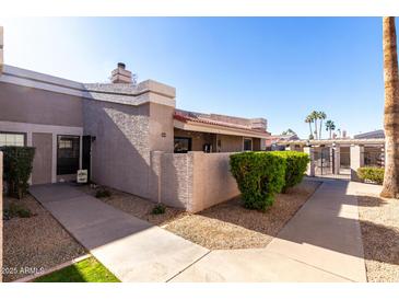 Inviting exterior of condo with well-manicured landscaping and walkway at 1976 N Lemon Tree Ln # 52, Chandler, AZ 85224