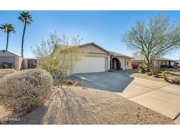 Single-story home with a two-car garage and desert landscaping at 3343 E Anderson Dr, Phoenix, AZ 85032