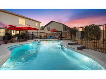 Inviting backyard pool with waterfall feature and ample patio space at 4360 E Sierrita Rd, San Tan Valley, AZ 85143