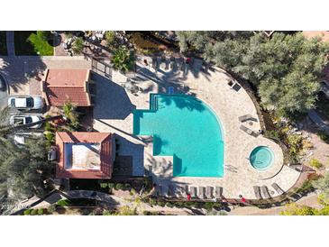 Community pool and spa with surrounding lounge chairs and landscaping at 5122 E Shea Blvd # 1100, Scottsdale, AZ 85254