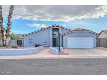 Single-story home with attached garage and landscaped front yard at 6339 W Ironwood W Dr, Glendale, AZ 85302