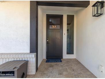 Modern front door entrance with a glass panel and tiled flooring at 8025 E Redwing Rd, Scottsdale, AZ 85250