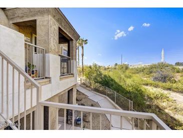 Building exterior with walkway, stairs, and desert landscape views at 12050 N Panorama Dr # 208, Fountain Hills, AZ 85268