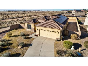 Single-story home with solar panels and desert landscaping at 1306 E Cecil Ct, Casa Grande, AZ 85122