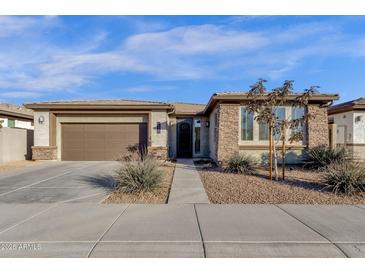 Single-story home with stone accents and a two-car garage at 1520 W Sonoqui Blvd, San Tan Valley, AZ 85140